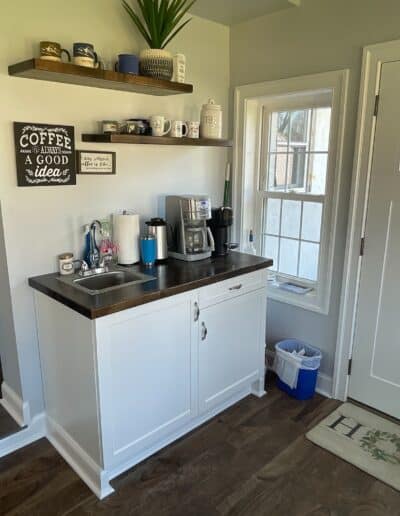 Custom coffee bar with floating shelves and butcher block countertop, crafted by MM Home Improvements in Berwyn