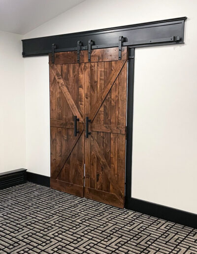 custom barn door at the addition project in Devon by MM Home Improvements.